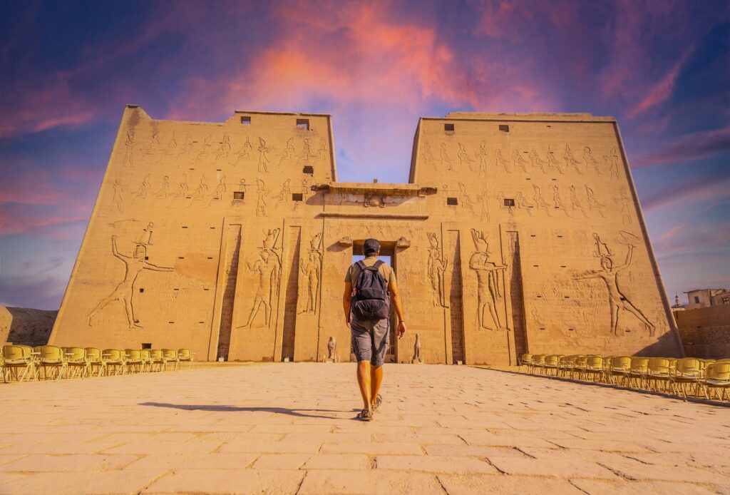 7 Enigmatic Temples of Ancient Egypt That Will Take Your Breath Away 6 A young tourist entering the Temple of Edfu