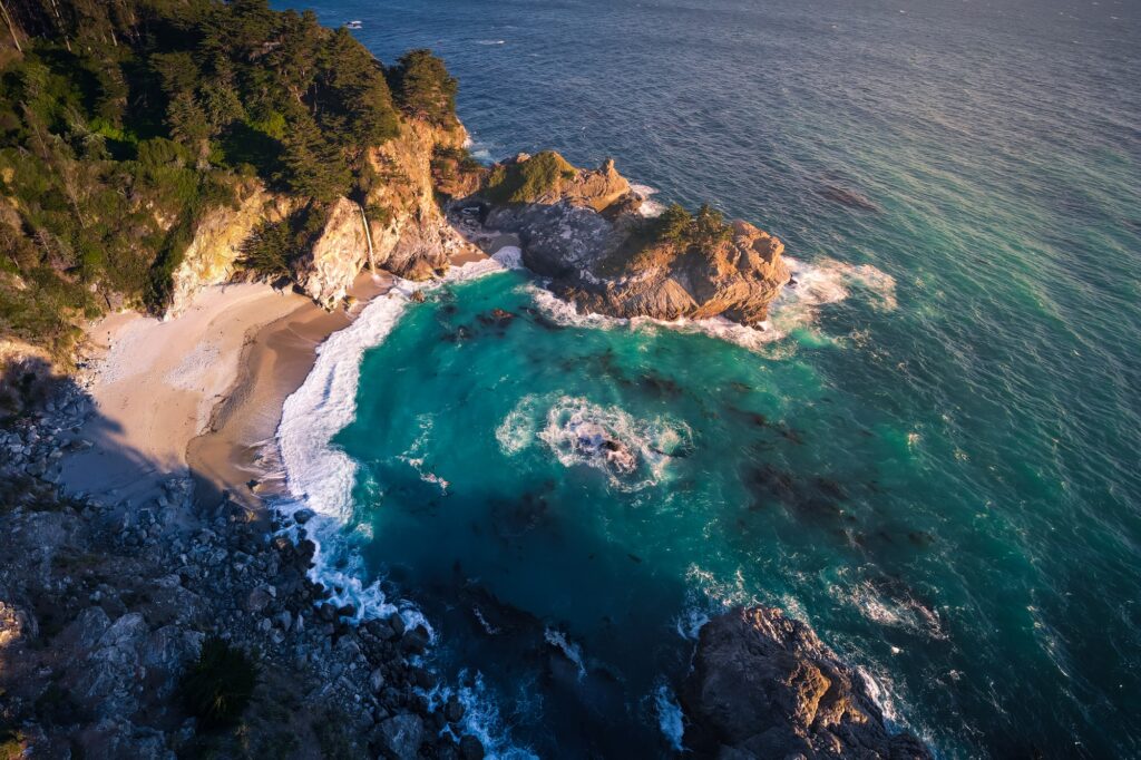 12 Mesmerizing Waterfalls You Absolutely Must Visit in the U.S. 9 Aerial View of McWay Falls and Cove Beach in BIg Sur, California