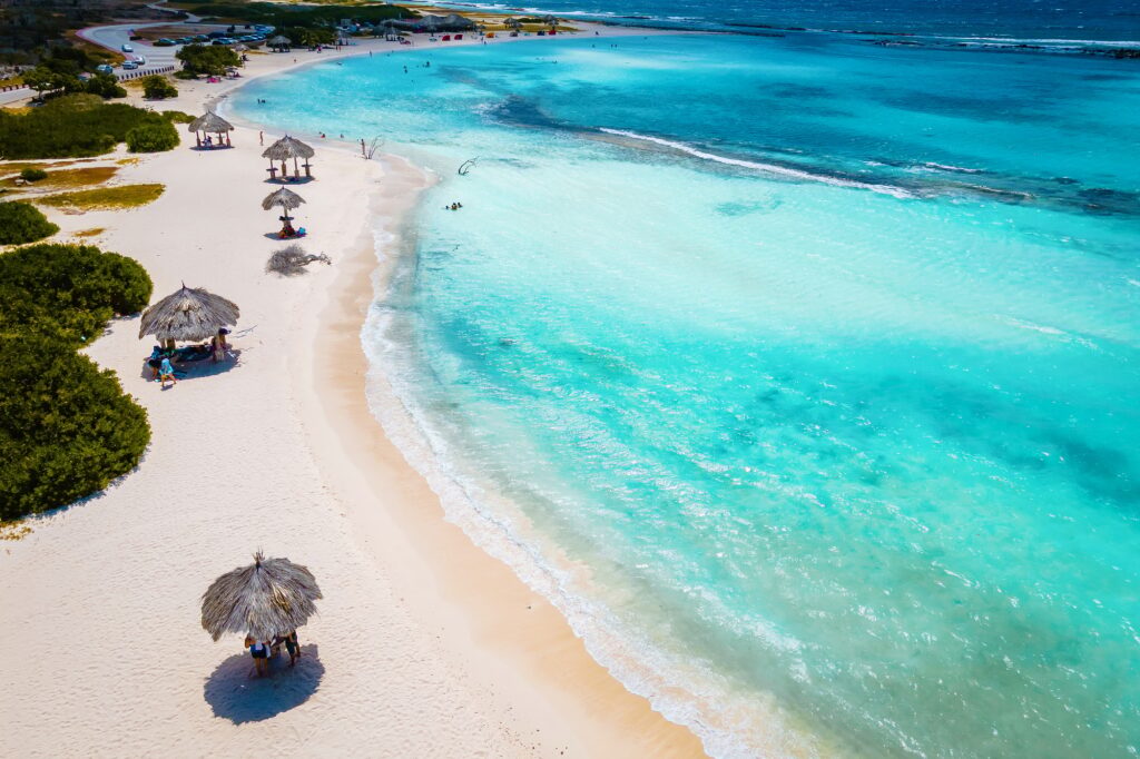 8 Enchanting Honeymoon Destinations to Ignite Your Love 6 Baby Beach and coast on Aruba, Caribbean, white beach with blue ocean tropical beach