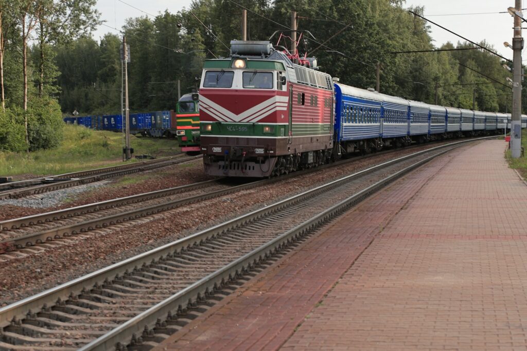 15 Extraordinary Destinations You Can’t Miss in Romania 8 a train traveling down train tracks next to a forest