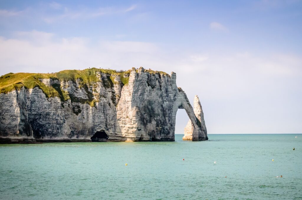 15 Extraordinary Sea Cliffs You Can’t Miss on Your Travels 14 Cliffs of Etretat in France in a blue sky summer day.