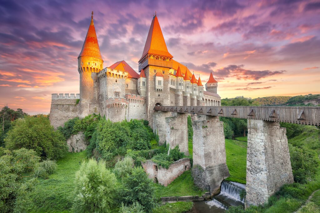 15 Extraordinary Destinations You Can’t Miss in Romania 6 Fabulous evening view of Hunyad Castle / Corvin's Castle with wooden bridge at sunset