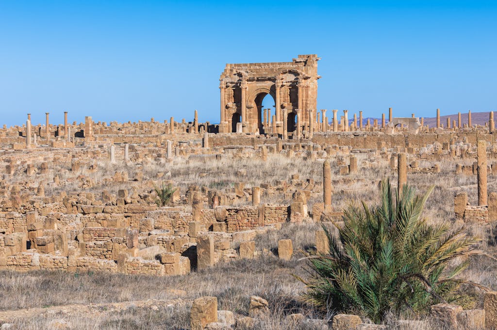 Explore the historical Roman ruins of Timgad with the iconic Arch of Trajan, Batna, Algeria.