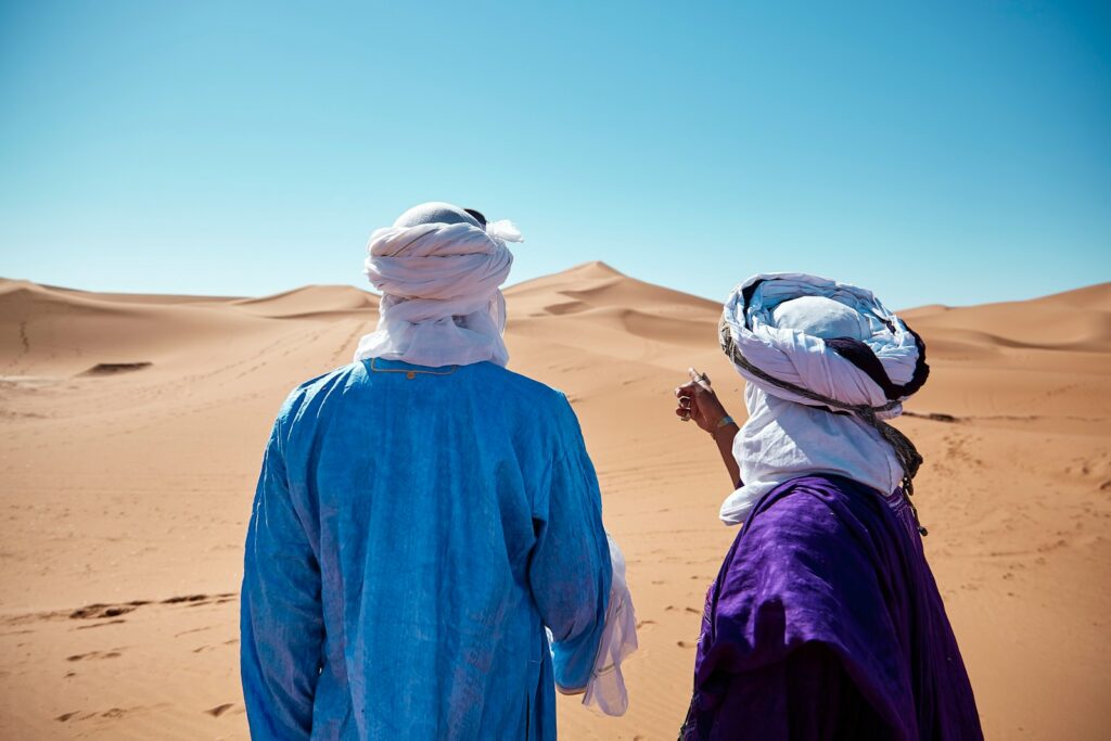 17 Enchanting Destinations in Morocco That You Must Experience 17 two persons standing on desert