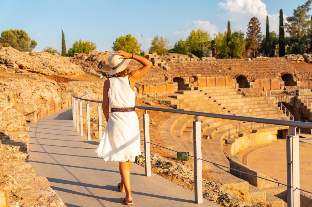 12 Ancient Roman Monuments That Will Transport You Through Time 4 Merida Roman Ruins, a young tourist in a dress at the Roman Amphitheater. Estremadura