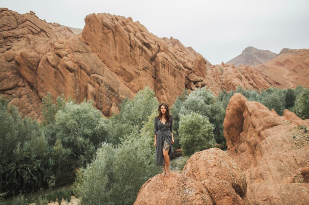 17 Enchanting Destinations in Morocco That You Must Experience 4 Portrait of beautiful european woman barefoot on background of Todra gorge canyon in Morocco