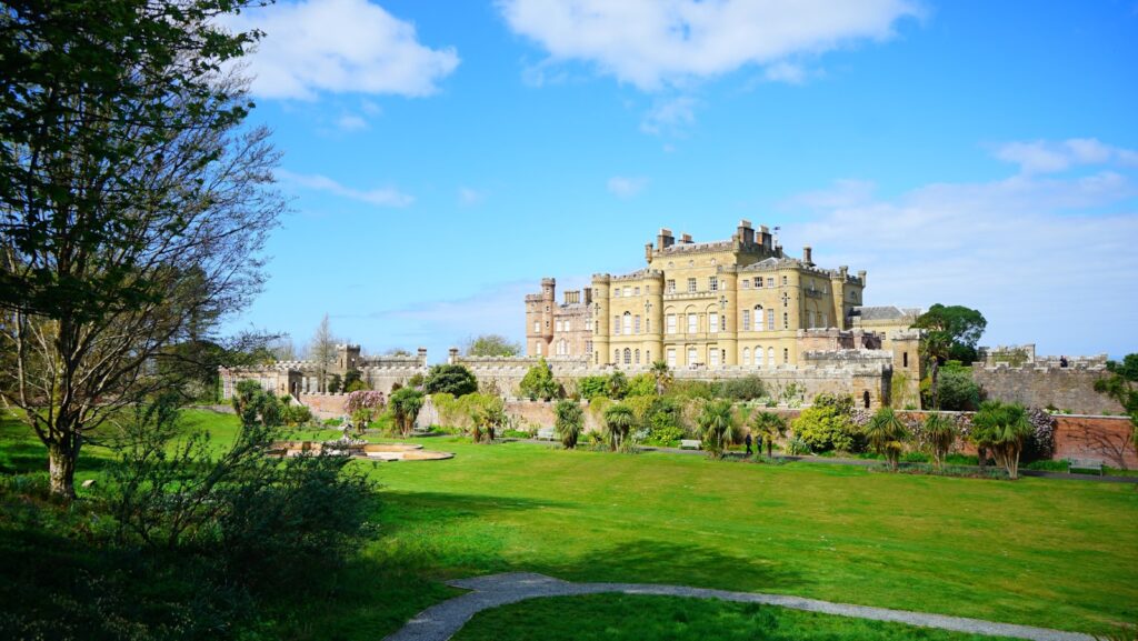 21 Enchanting Castles in Scotland You Must Explore 21 a large building with trees and grass with Culzean Castle in the background