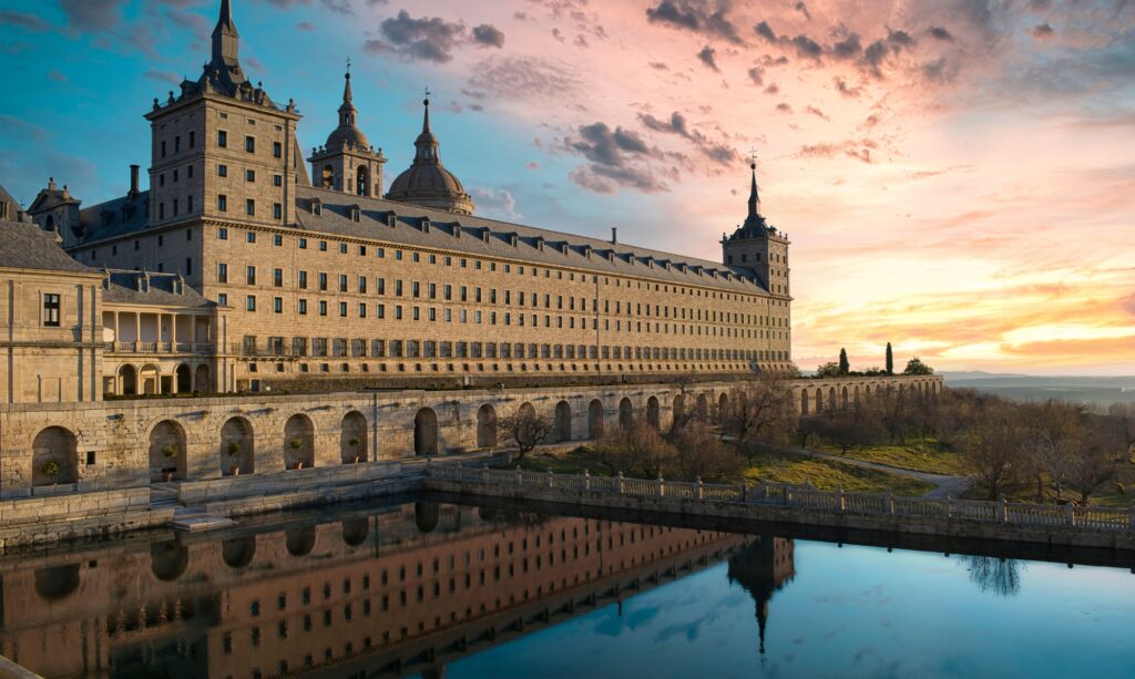 10 Enchanting Christian Monasteries Around the World That You Must Visit 11 Reflection on the water of a pond of the majestic royal monastery of San Lorenzo de El Escorial