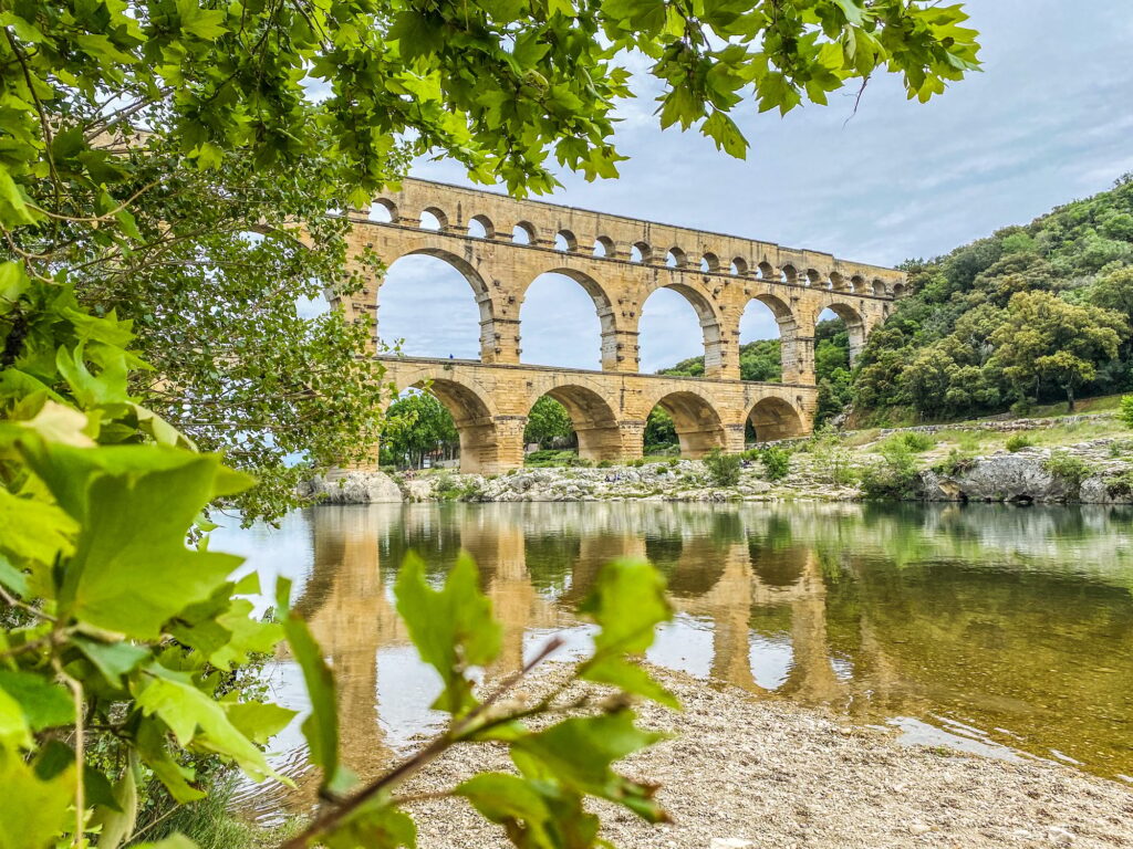 12 Ancient Roman Monuments That Will Transport You Through Time 12 Roman aqueduct seen through foliage, Pont-du-Gard, Languedoc-Roussillon France