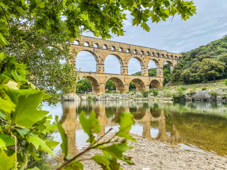 Roman aqueduct seen through foliage, Pont-du-Gard, Languedoc-Roussillon France