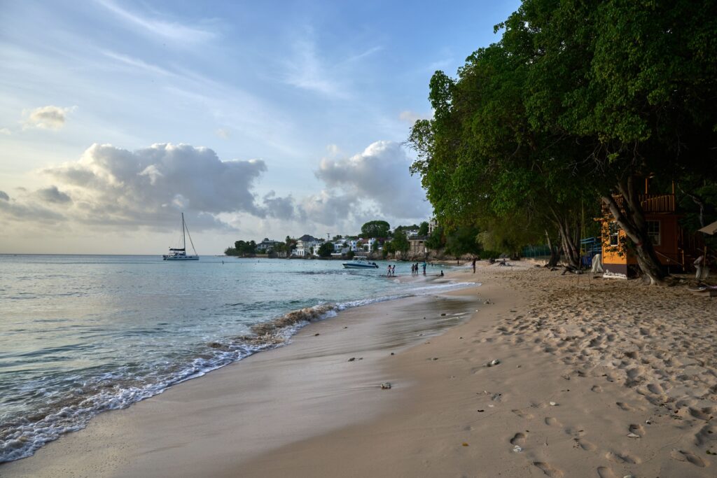 10 Unforgettable Party Islands You Need to Experience 11 Soft sandy Batts Rock beach in Barbados, seashore with green trees and white little houses