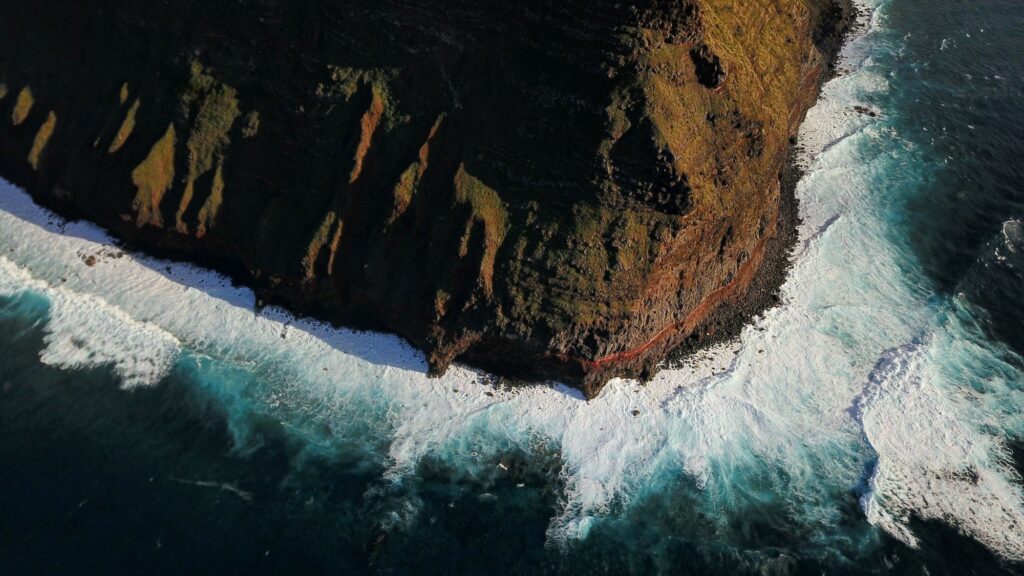 15 Extraordinary Sea Cliffs You Can’t Miss on Your Travels 5 Top aerial of Molokai island and Kalaupapa cliffs against sunny and cloudy sky in the background