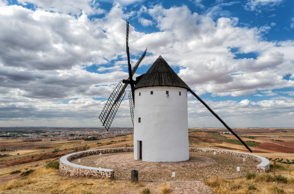 6 Enchanting Old Windmills You Have to See 5 Windmill against a cloudy sky in Castilla-La Mancha, Spain