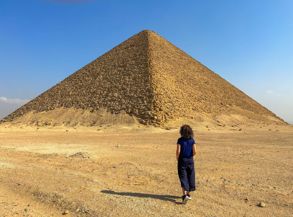 8 Extraordinary Pyramids You Can't Miss 5 Woman from behind walking by the desert to the Red Pyramid in Dahshur, Egypt