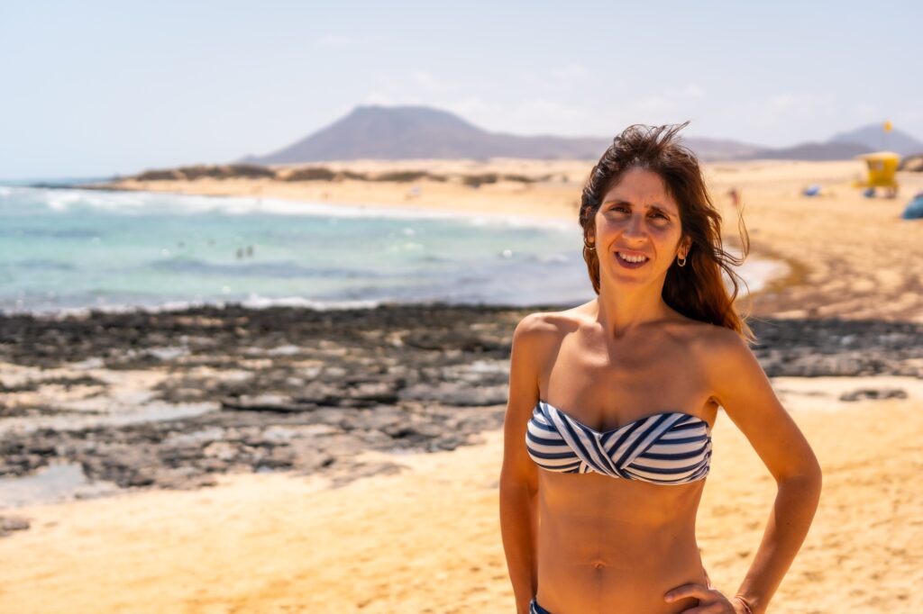 10 Enchanting Beaches in the Canary Islands You Cannot Miss 2 A young tourist on the beaches of the Corralejo Natural Park, Fuerteventura