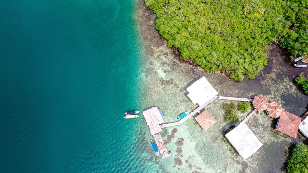 15 Extraordinary Places You Can’t Miss in Panama City 5 Aerial shot of a green island surrounded by tranquil ocean water in Bocas del Toro, Panama.