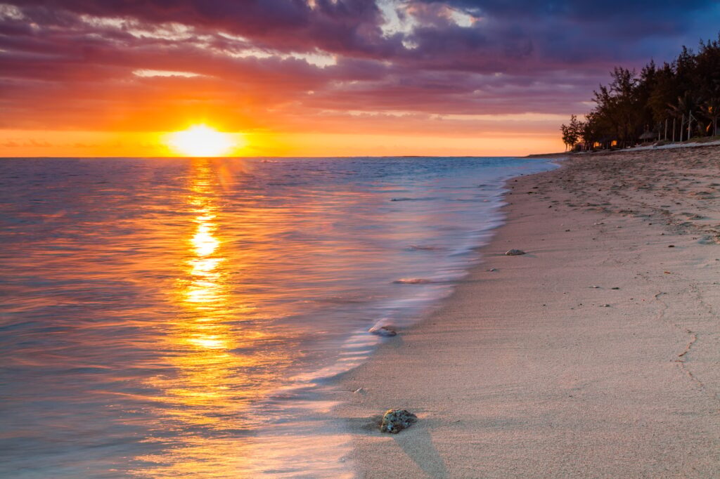 10 Enchanting Islands in Africa You Simply Can't Miss 11 Beautiful sunset on the beach in a tropical resort at Reunion island.