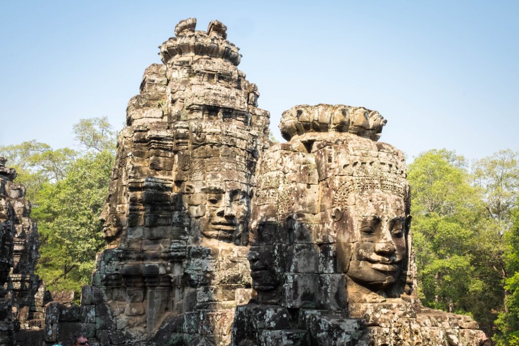 18 Enchanting Destinations in Cambodia You Can’t Miss 19 Buddhist smiling faces on towers at Bayon Temple, Cambodia