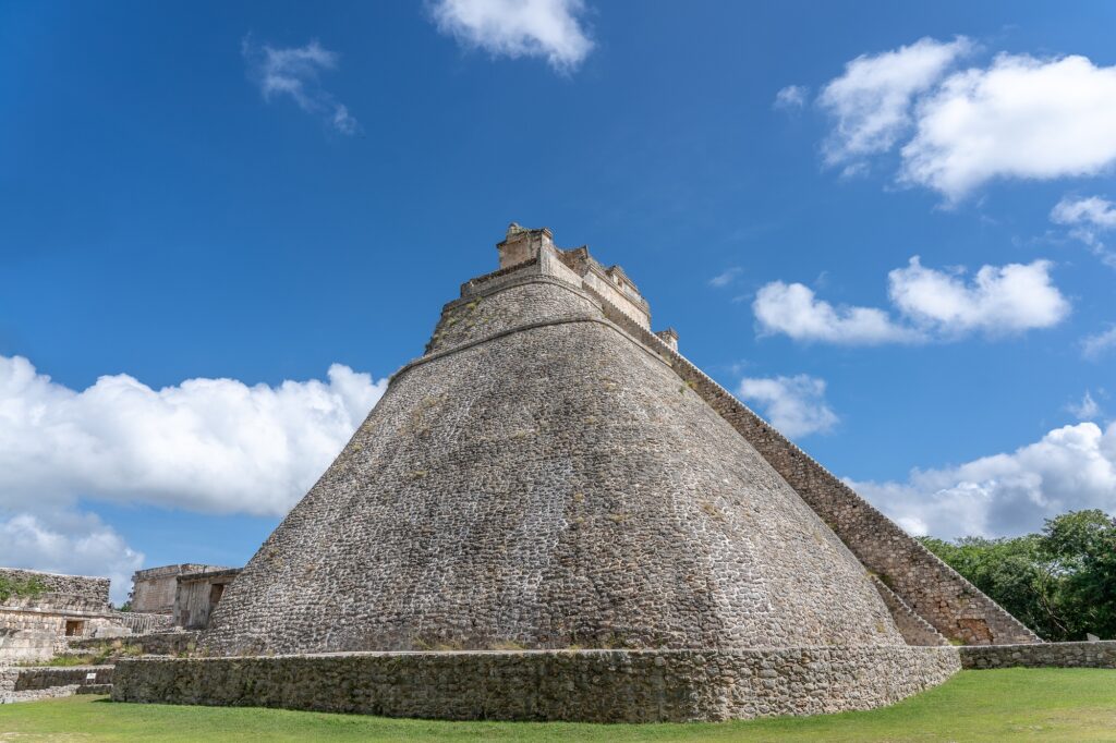 12 Remarkable Step Pyramids Around the World You Must Explore 11 Low angle shot of the Pyramid of the Magician Uxmal in Mexico under a blue sky