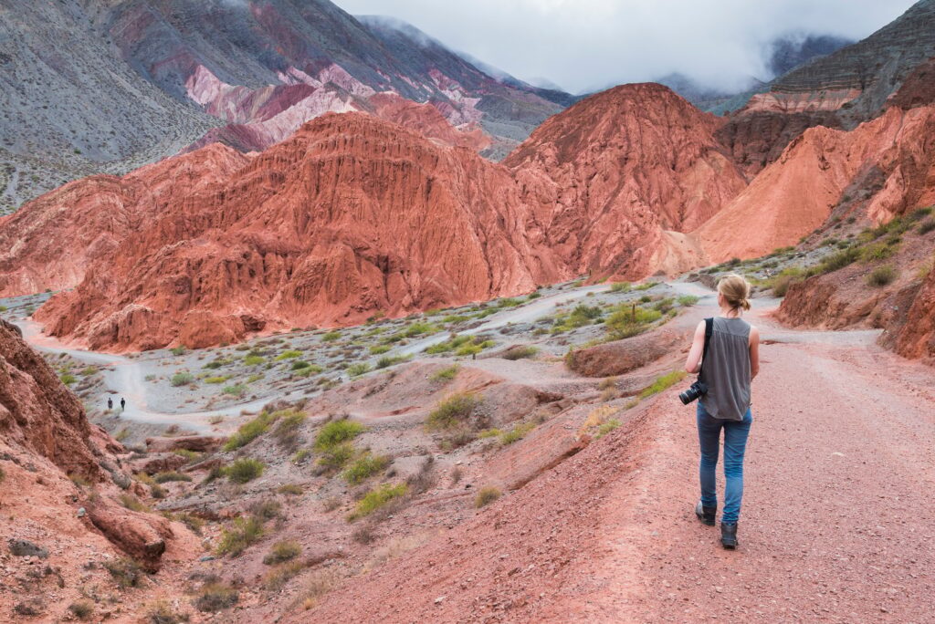 Discovering Argentina: 23 Extraordinary Attractions You Can’t Miss 16 Woman on the trek around the Hill of Seven Colours (Cerro de los Siete Colores), Quebrada de Purmama